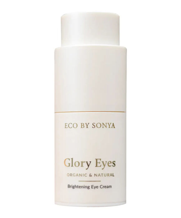 A white cylindrical bottle of Eco By Sonya Glory Eyes Brightening Eye Cream, featuring gold lettering and a thin gold horizontal line on a clean white background.